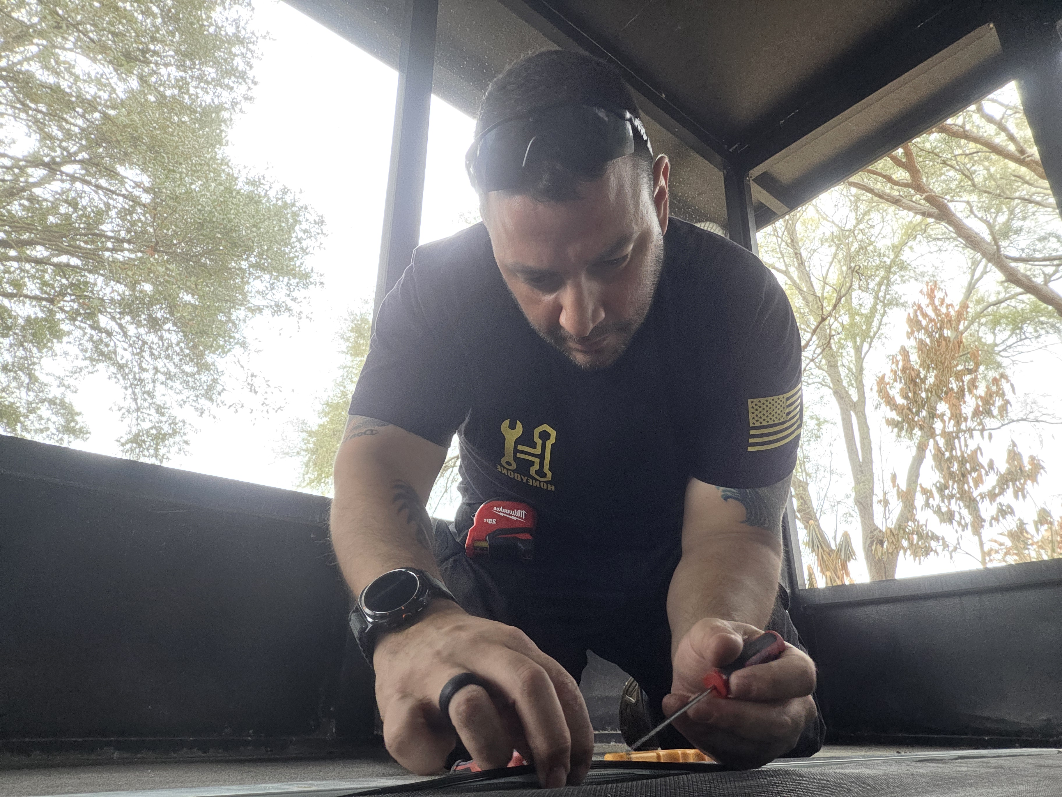 Manny Rivero, owner of HoneyDone, working on a screen repair job in Brevard County FL